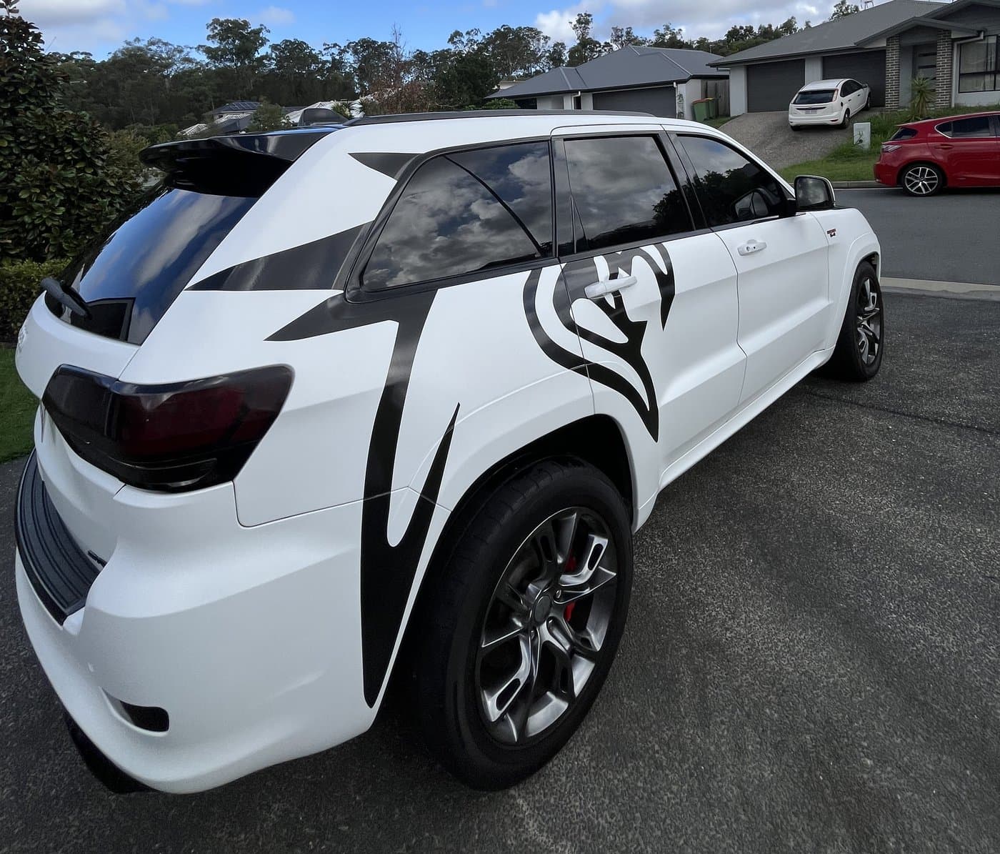 White SUV with custom black tribal graphic wrap