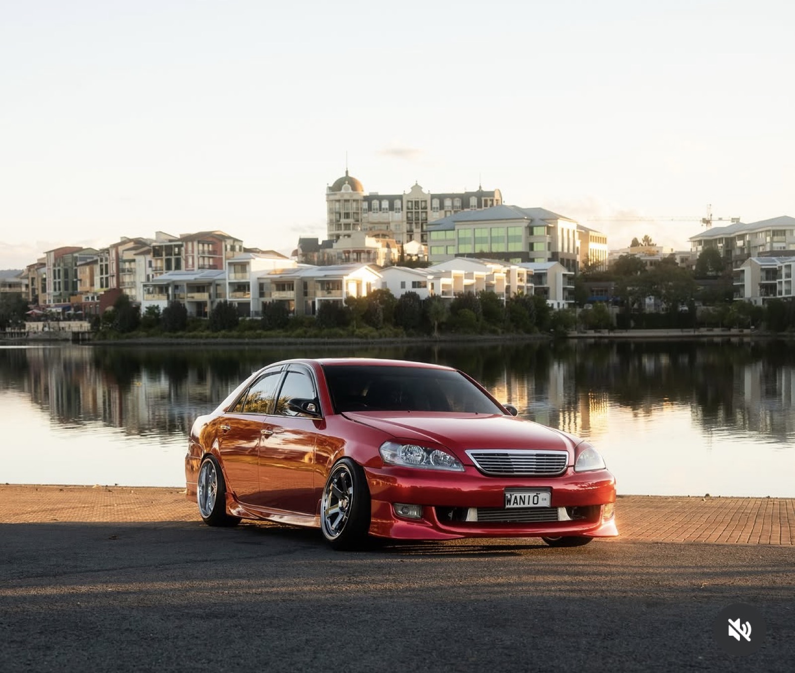 Candy red Toyota Mark II gloss colour-change wrap by the water at sunset, Gold Coast